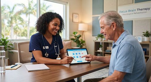 A warm, brightly lit clinical setting with a diverse female therapist gently guiding a senior male patient through a cognitive exercise on a tablet.